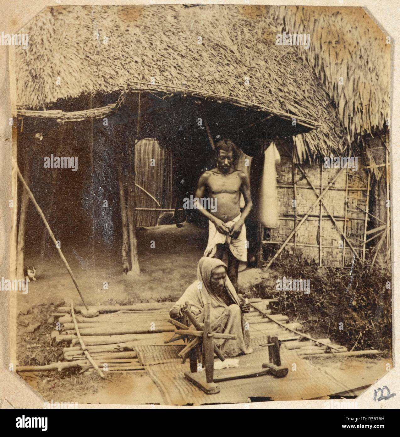 A view of a woman spinning outside a hut. (Winship Collection). 1860s. Photograph. Source: Photo 798/(122). Author: UNKNOWN. Stock Photo