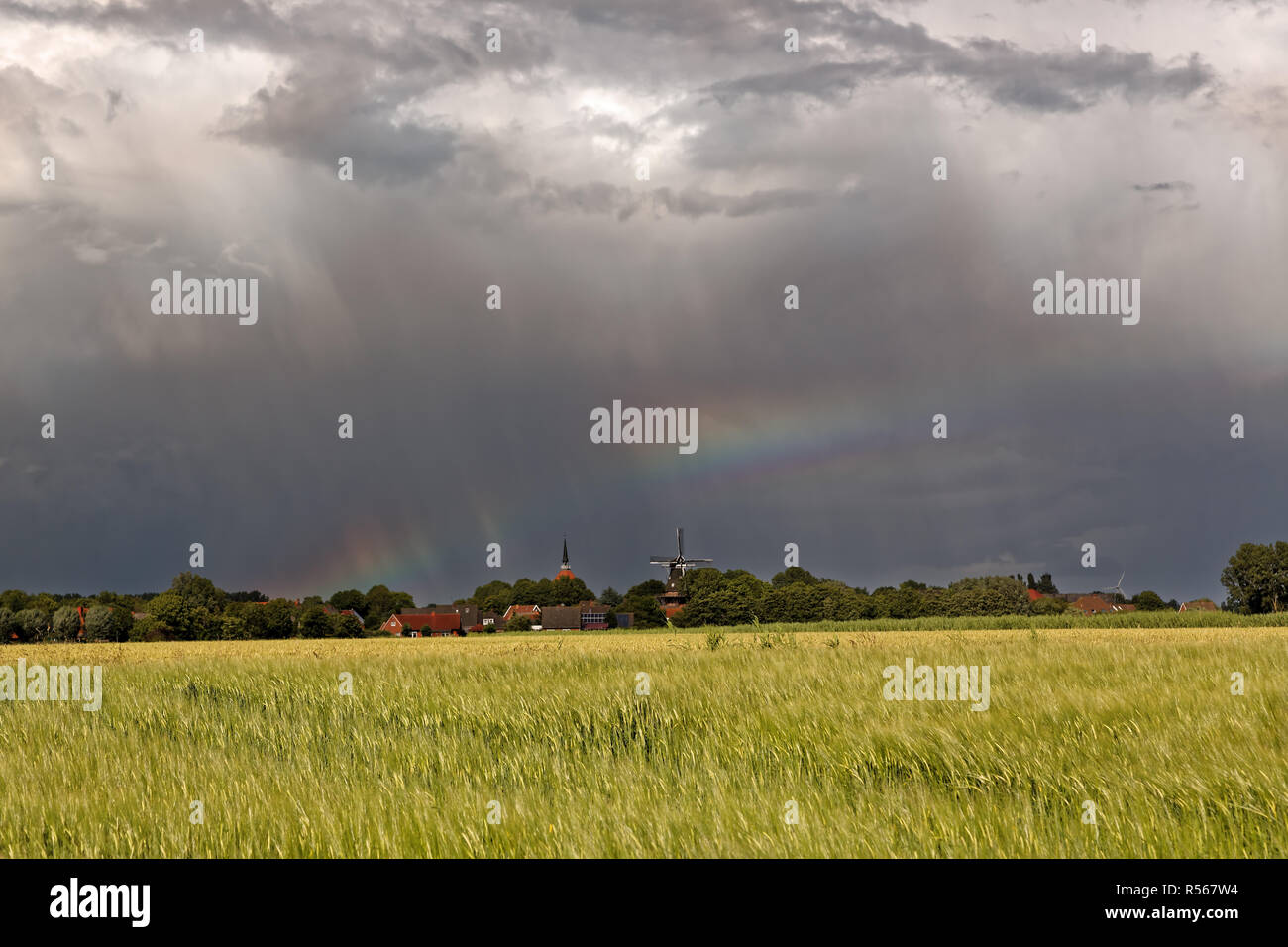 rainbow over rysum in east frisia Stock Photo