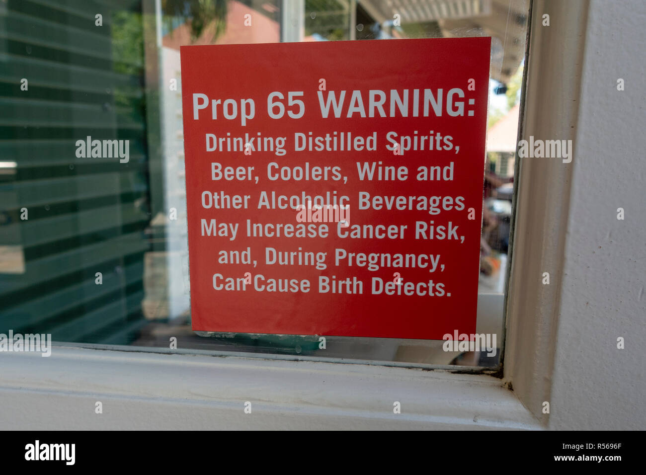 A 'prop 65 WARNING' sign on display outside a cafe in San Diego Zoo, Balboa Park, California, United States. Stock Photo