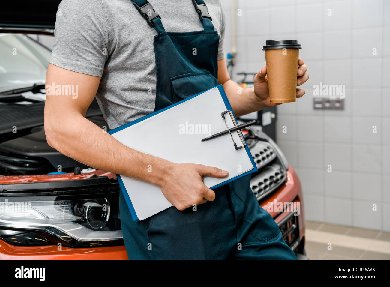 Auto Repair Nearby >> Partial View Of Male Auto Mechanic With Notepad And Coffee Auto Repair Nearby >> Partial View Of Male Auto Mechanic With Notepad And Coffee
