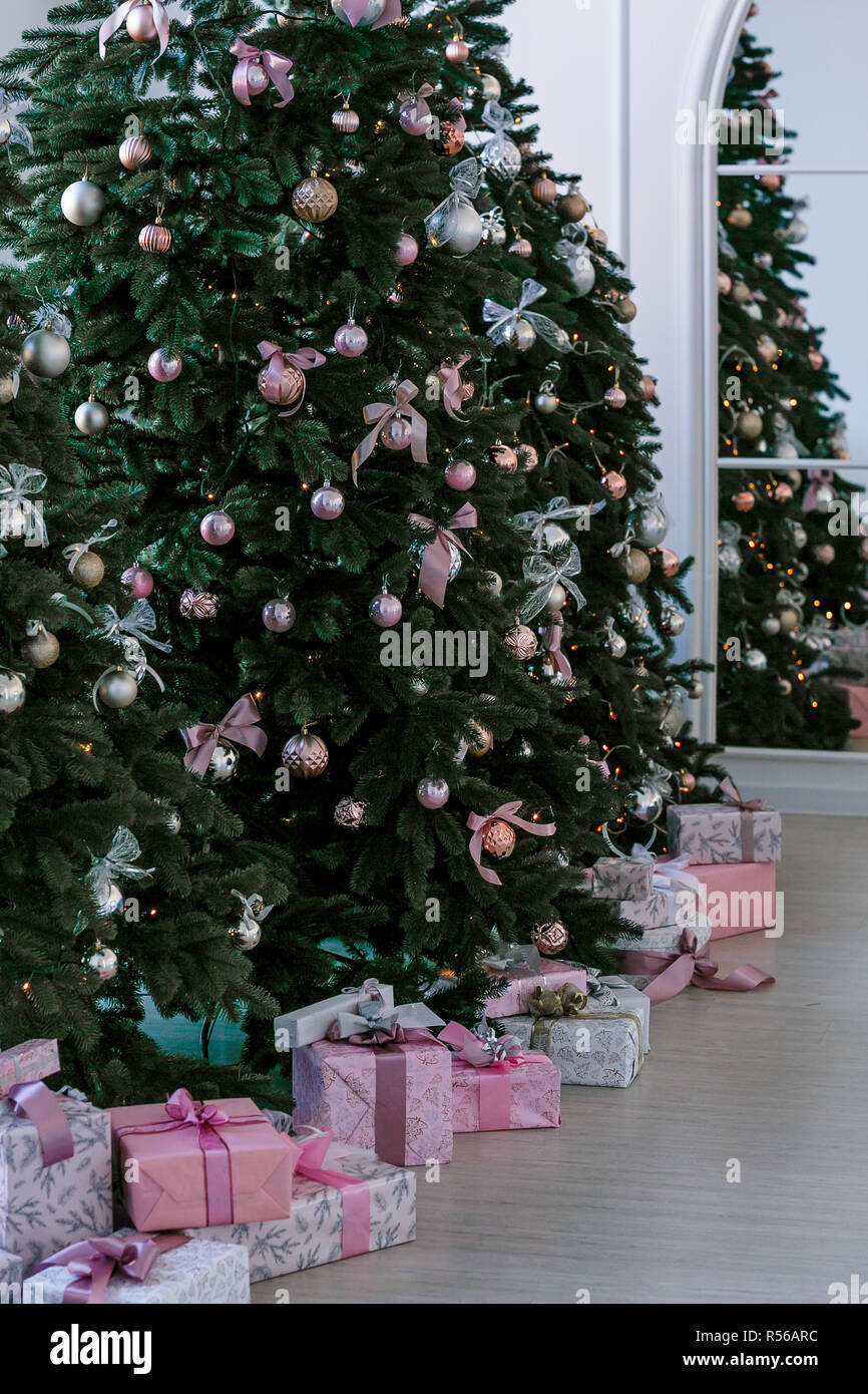 various gifts under beautiful Christmas trees Stock Photo