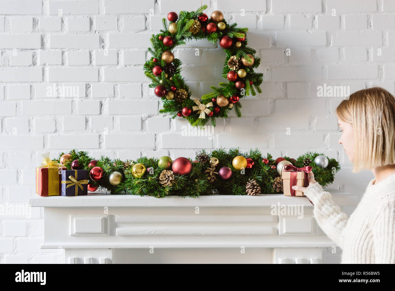 Christmas Wreath And Decorations Over Fireplace Mantel With White