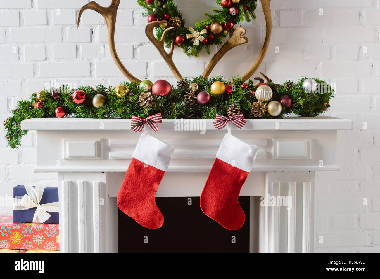 Christmas Wreath With Decorations Stockings And Deer Horns Over