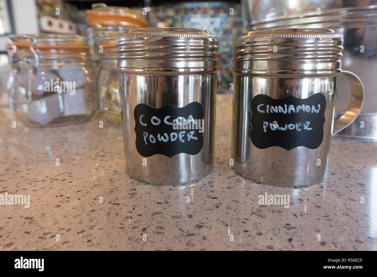 Shiny Canisters Of Cocoa Powder And Cinnamon Powder On Kitchen Counter In Cool Retro Kitchen Stock Photo Alamy