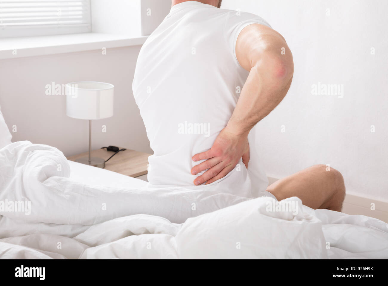 Man Sitting On Bed Having Back Pain Stock Photo Alamy