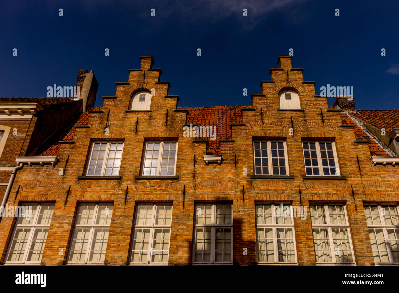 Bruges, Belgium - 17 February 2018: Gable on top of a red brick building at Bruges Stock Photo