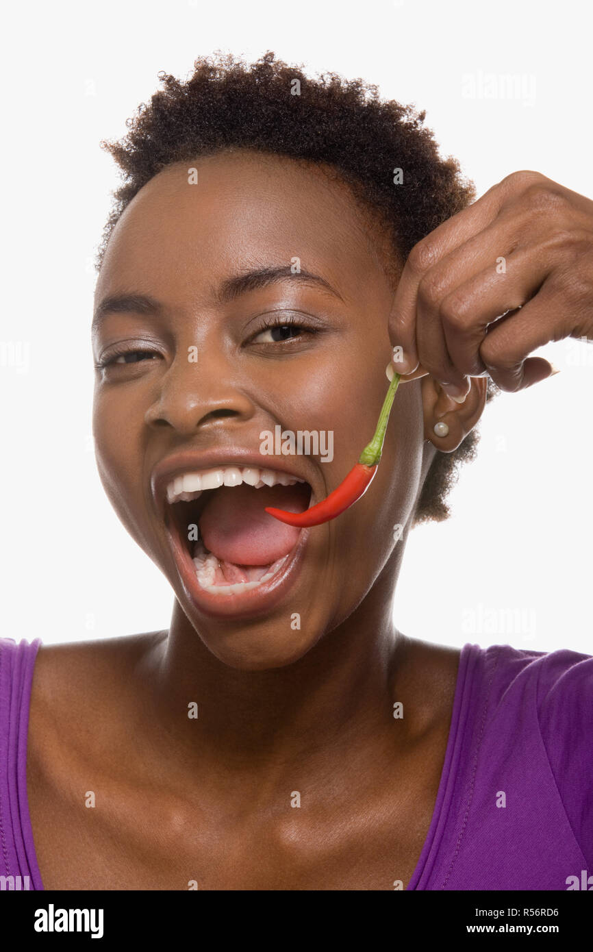 Woman eating chili pepper Stock Photo Alamy