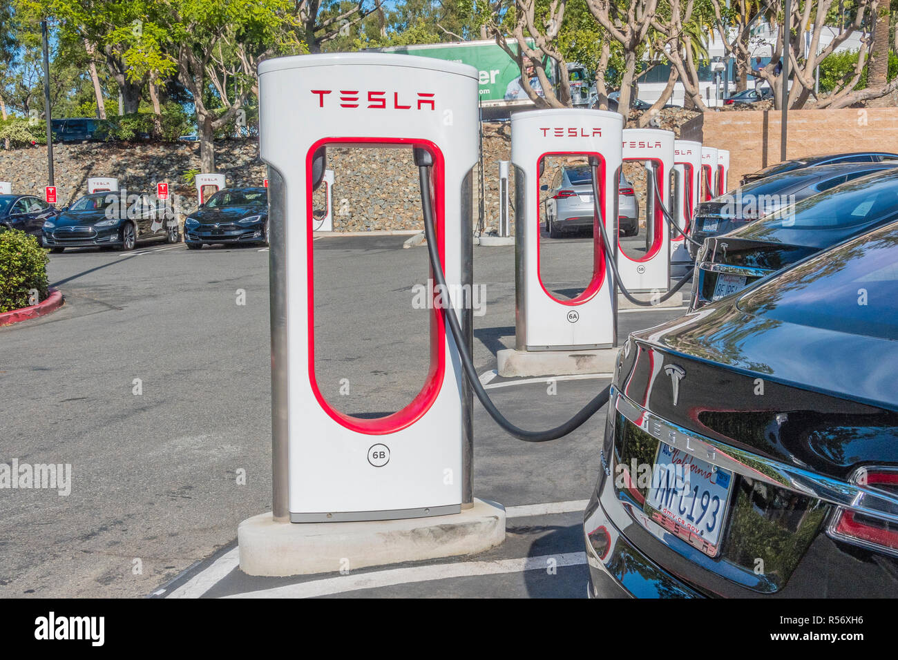 Many Tesla electric cars charging at the Tesla supercharging station in Culver City, California