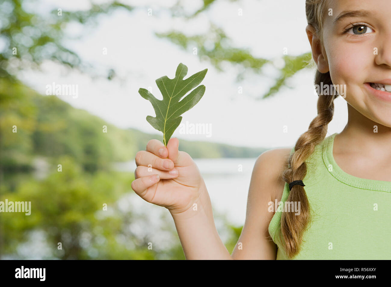Girl holding a leaf Stock Photo - Alamy