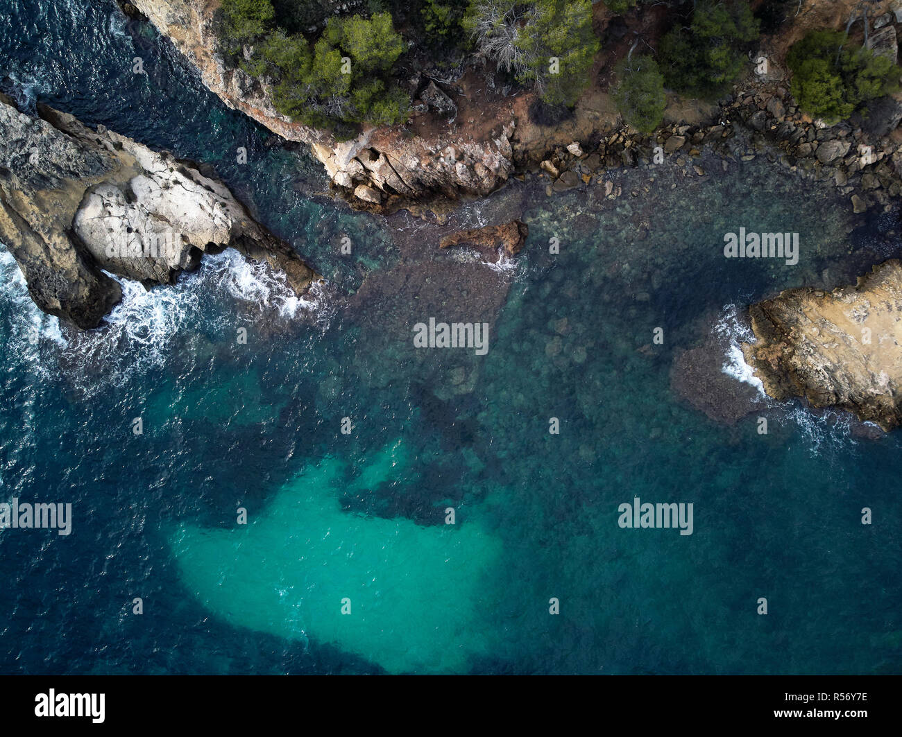 Cap falco beach with turquoise green transparent water and rocky coast, view directly from above. Aerial drone photography. Mallorca or Majorca Island Stock Photo