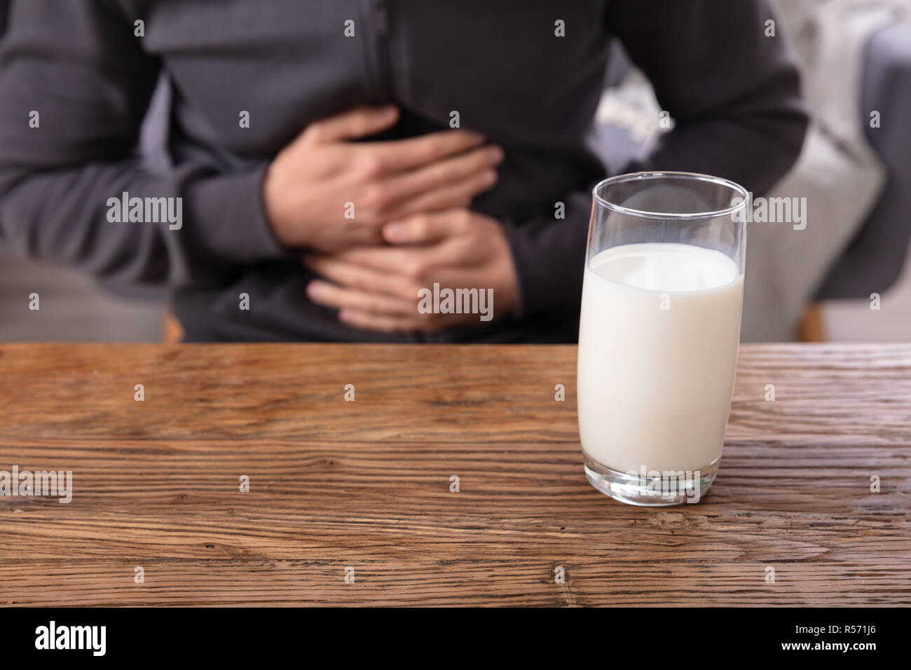 Midsection View Of A Man Suffering From Stomach Pain Holding Glass Of