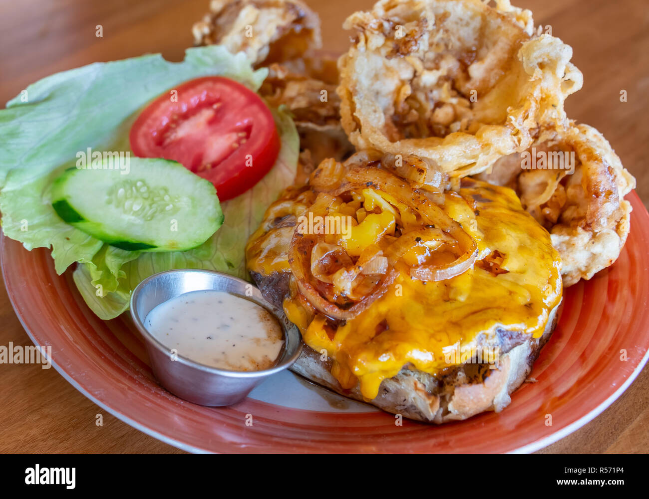 Cheeseburger with handmade onion rings Stock Photo Alamy