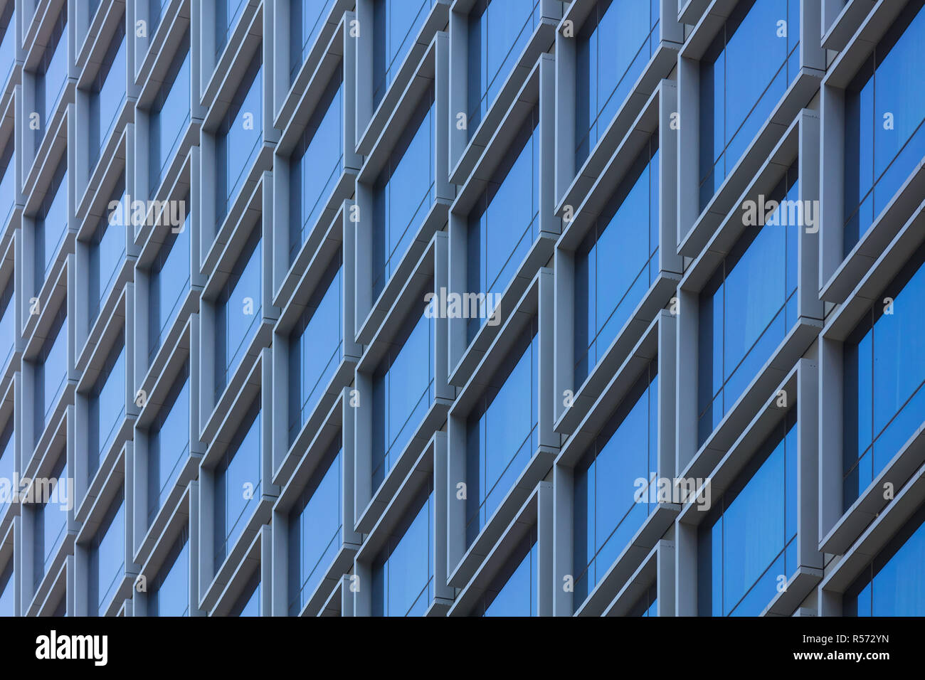 An abstract pattern of square windows on a residential tower block Stock Photo