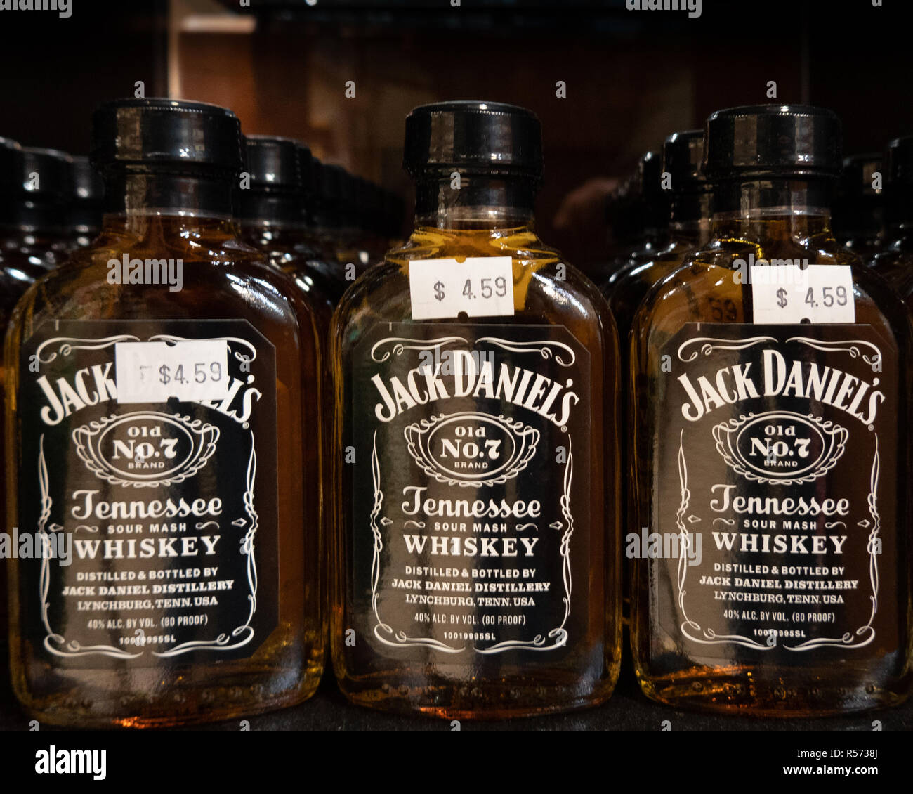 A shelf full of bottles of Jack Daniel's Old No. 7 Tennessee Sour Mash Whiskey for sale in a liquor store. Stock Photo