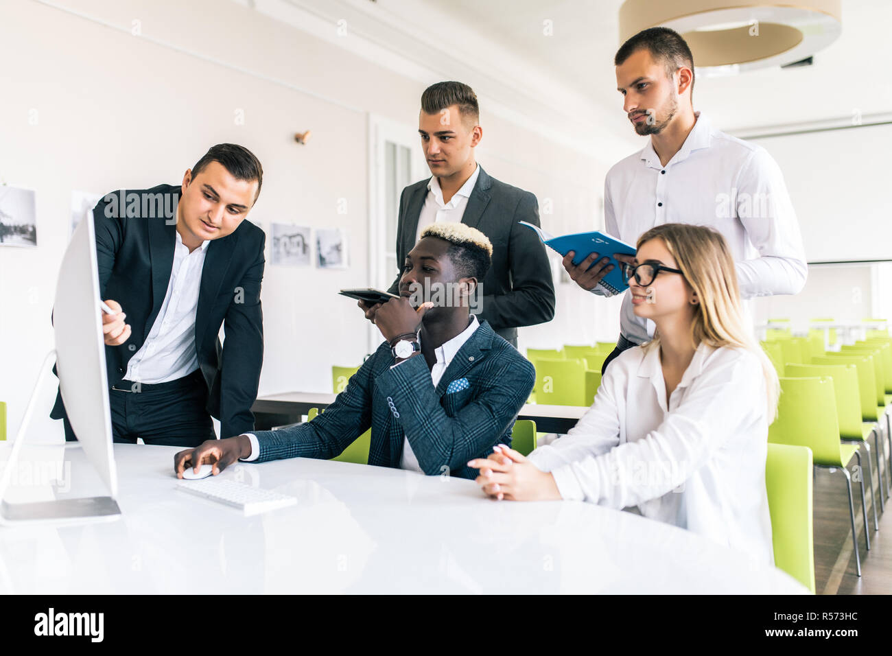 Young creative managers team working with new project in modern office. Stock Photo