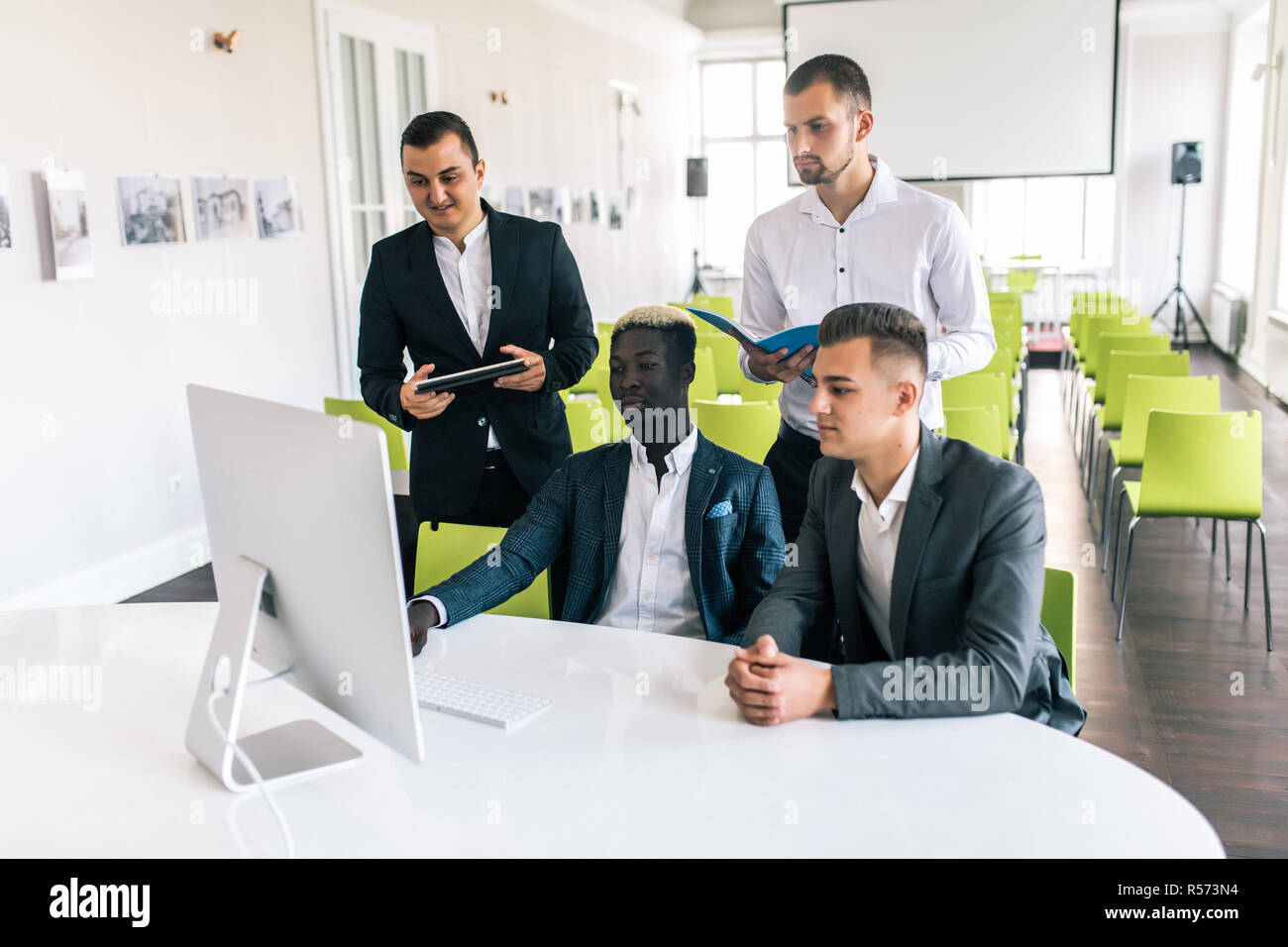 Young creative managers team working with new project in modern office. Stock Photo
