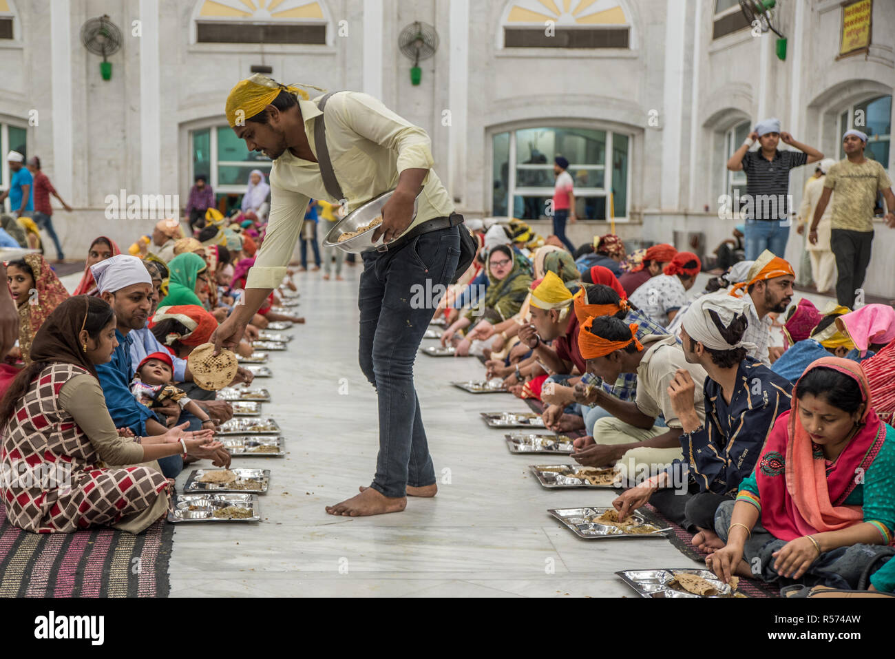 People having langar (free food) at Gurudwara Bangla Sahib Sikh house ...