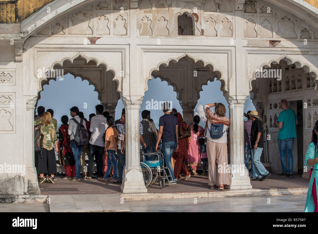 Tourists under arches on White Marble Palace inside Agra Fort, Uttar Pradesh, India Stock Photo