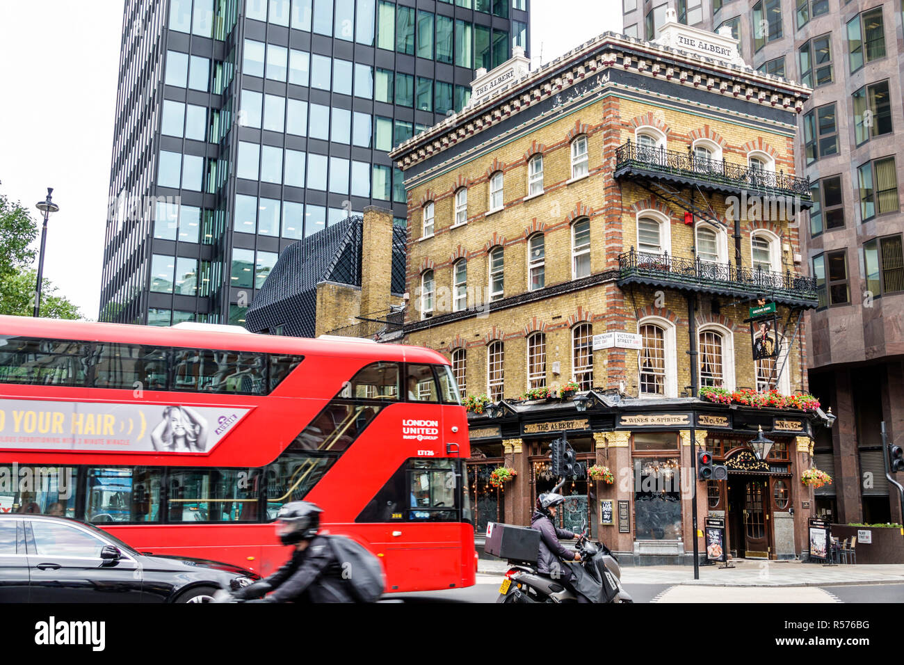 London England,UK,Westminster,Victoria Street,The Albert Pub,Victorian public house,building exterior,red double-decker bus,intersection,motorcycle,UK Stock Photo