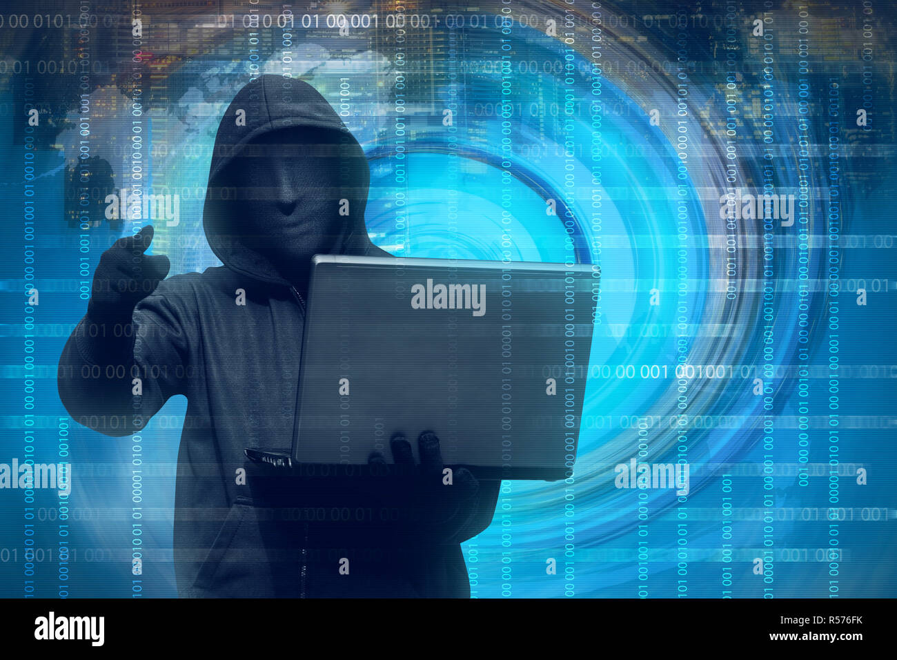 Hooded man with mask holding laptop Stock Photo - Alamy