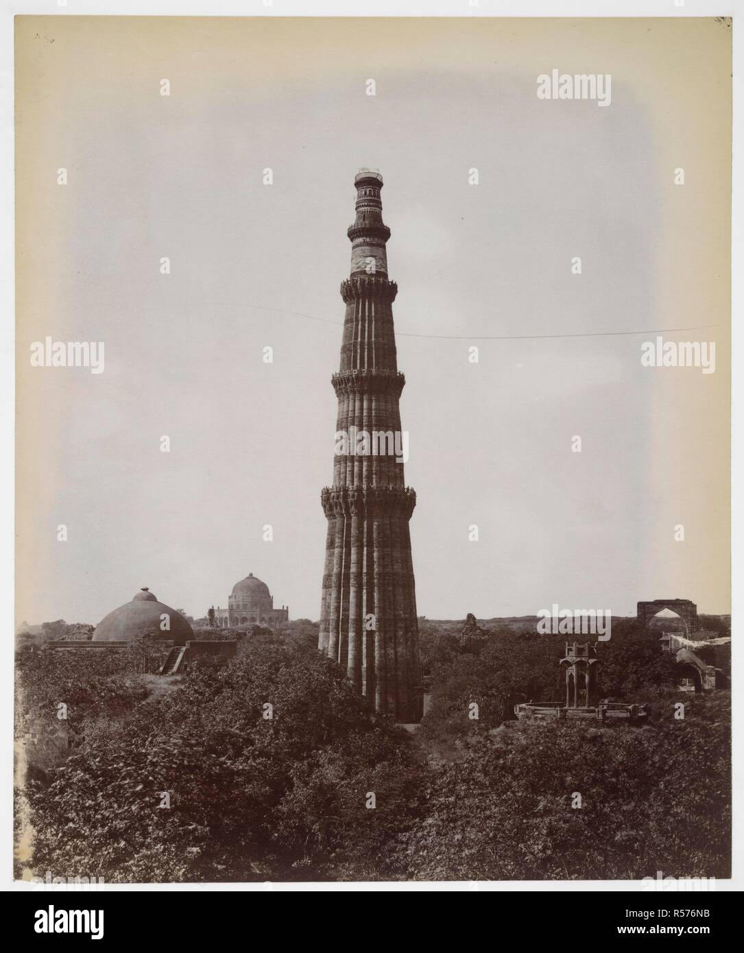 General view of the Qutb Minar, Delhi. A view from the east looking towards the tower of victory, with the dome of the Alai Darwaza on the left, and the small pavilion, a late addition that for a time stood at the top of the tower, on the right. Adham Khan's Tomb can be seen in the background to the left of the Qutb. Archaeological Survey of India Collections: Indian Museum Series (Duplicates). 1870s. Photograph. Source: Photo 1003/(879). Stock Photo