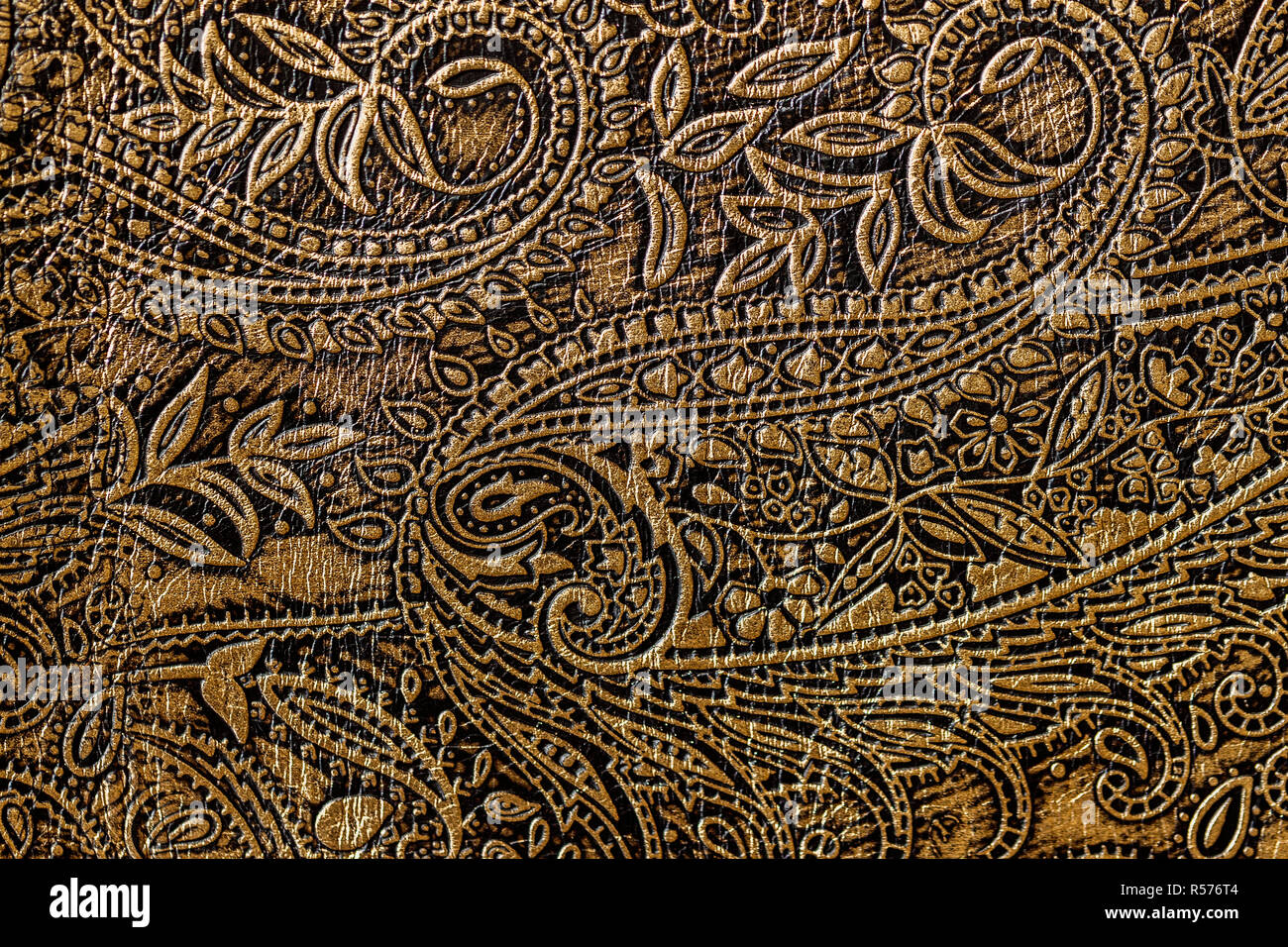 Texture of golden brown genuine leather close-up, with embossed floral  trend pattern, wallpaper or banner design Stock Photo - Alamy
