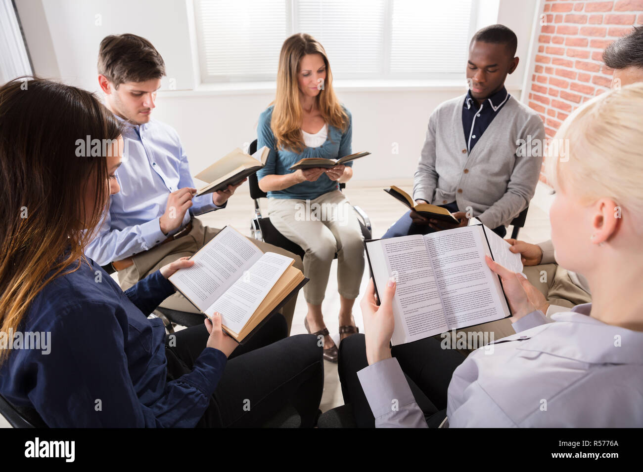 Group Of People Reading Bibles Stock Photo
