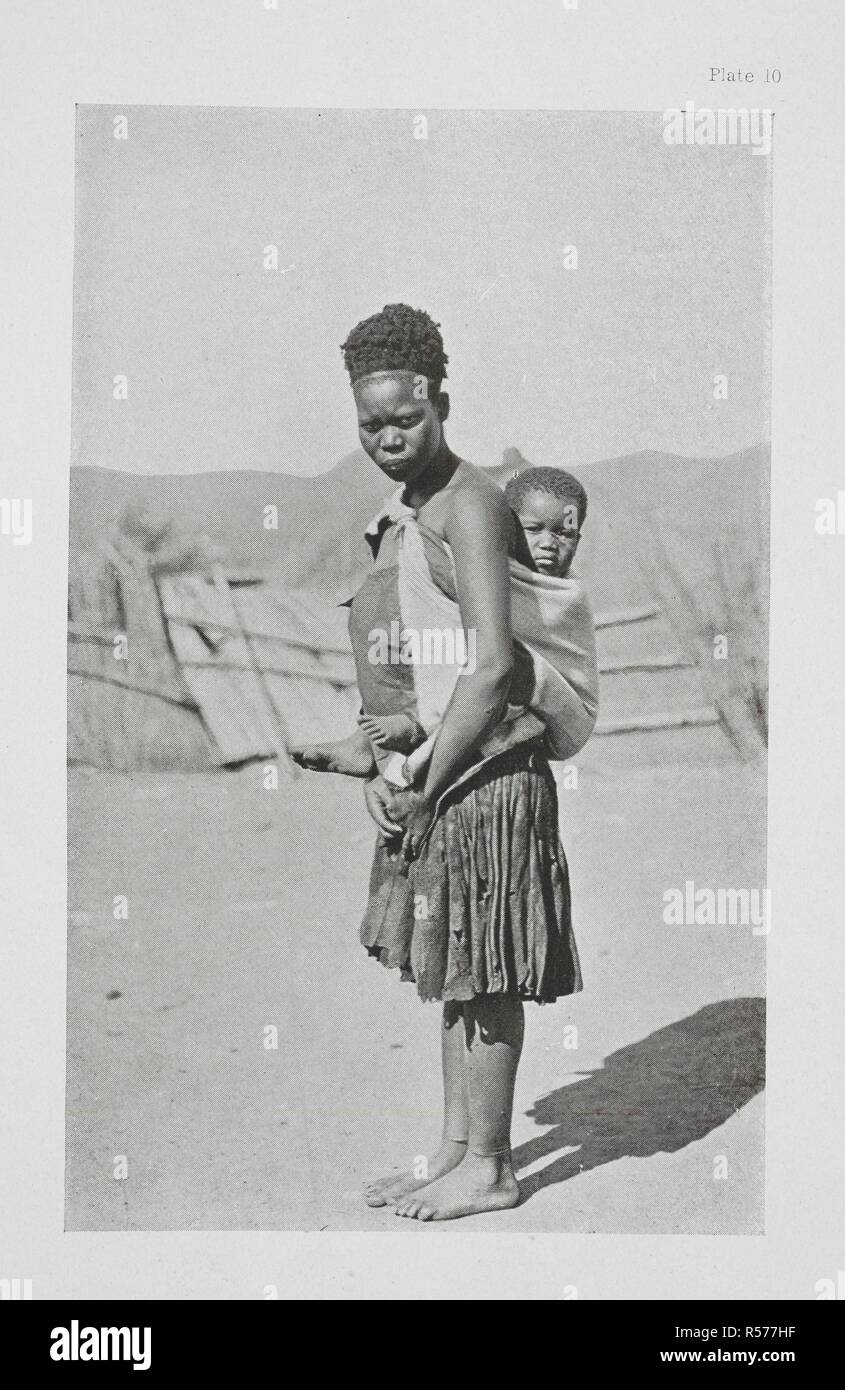 Mother and baby.  This is a typical Swazie mother in her typical skin shirt, which is of deep black. The baby shows the usual sorres around the eyes, and flies can be seen on the face. The Essential Kafir ... With one hundred full-page illustrations by the author. London : Adam & Charles Black, 1904. Source: 10096.h.20 plate 10. Author: Kidd, Dudley. Stock Photo