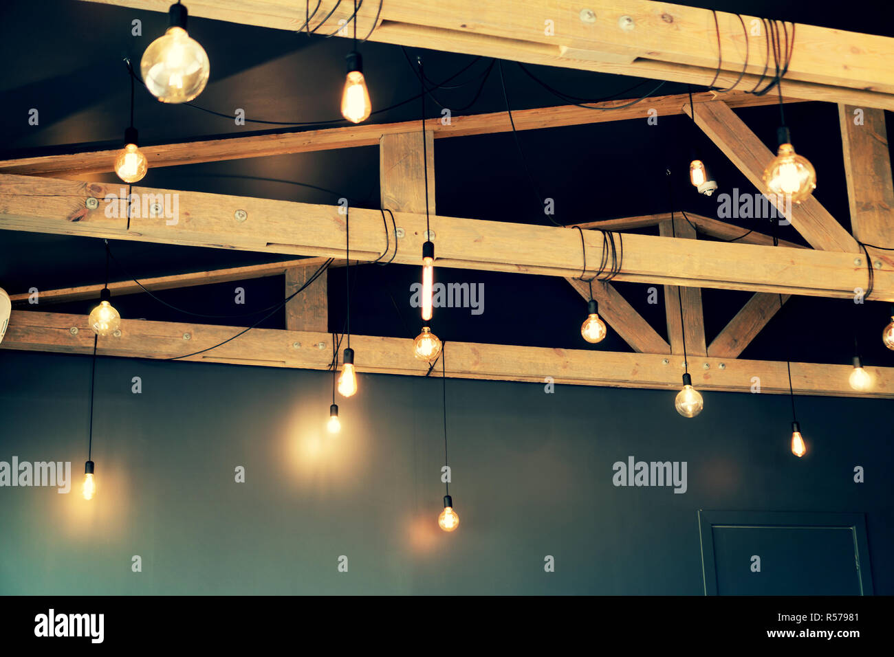 Light bulbs hanging from the ceiling hires stock photography and
