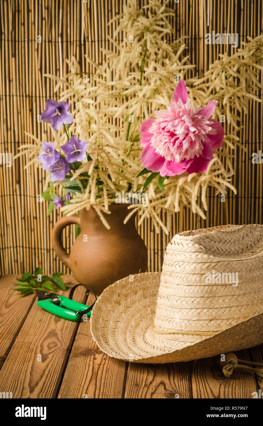 Straw hat and peony flower, close-up Stock Photo