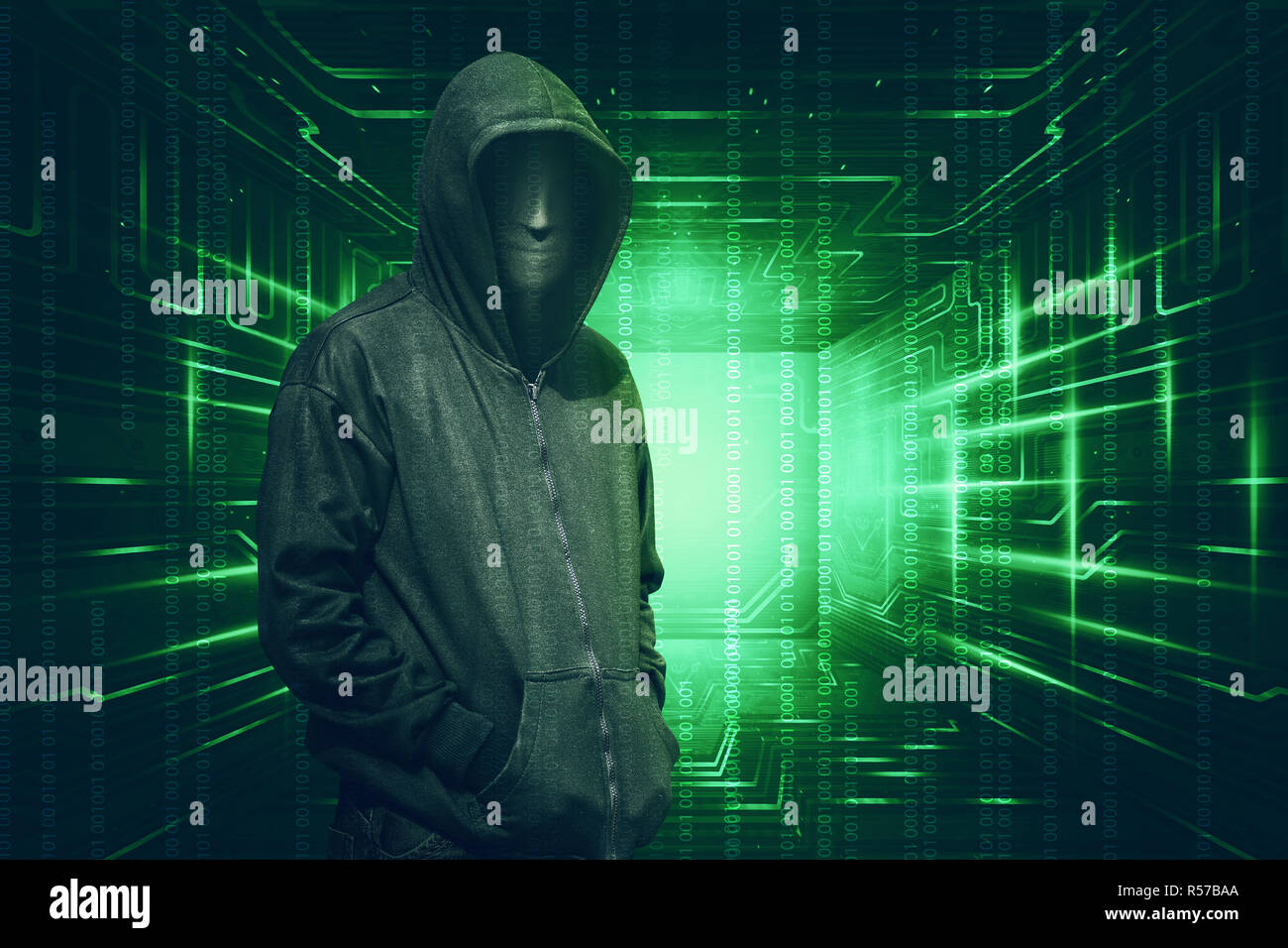 Hooded with anonymous mask standing with binary code Stock Photo - Alamy