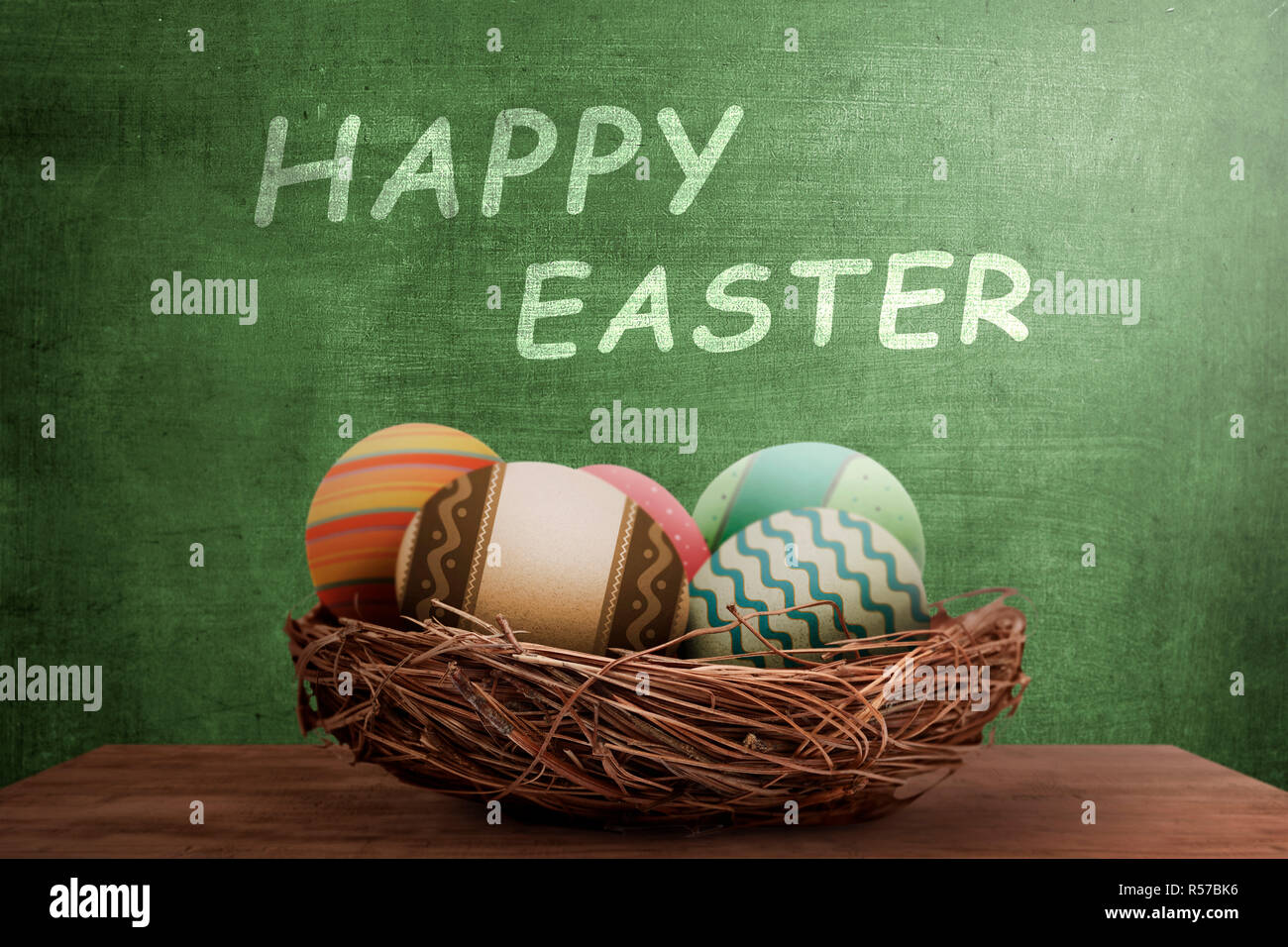 Easter eggs in nest with happy easter greeting Stock Photo - Alamy