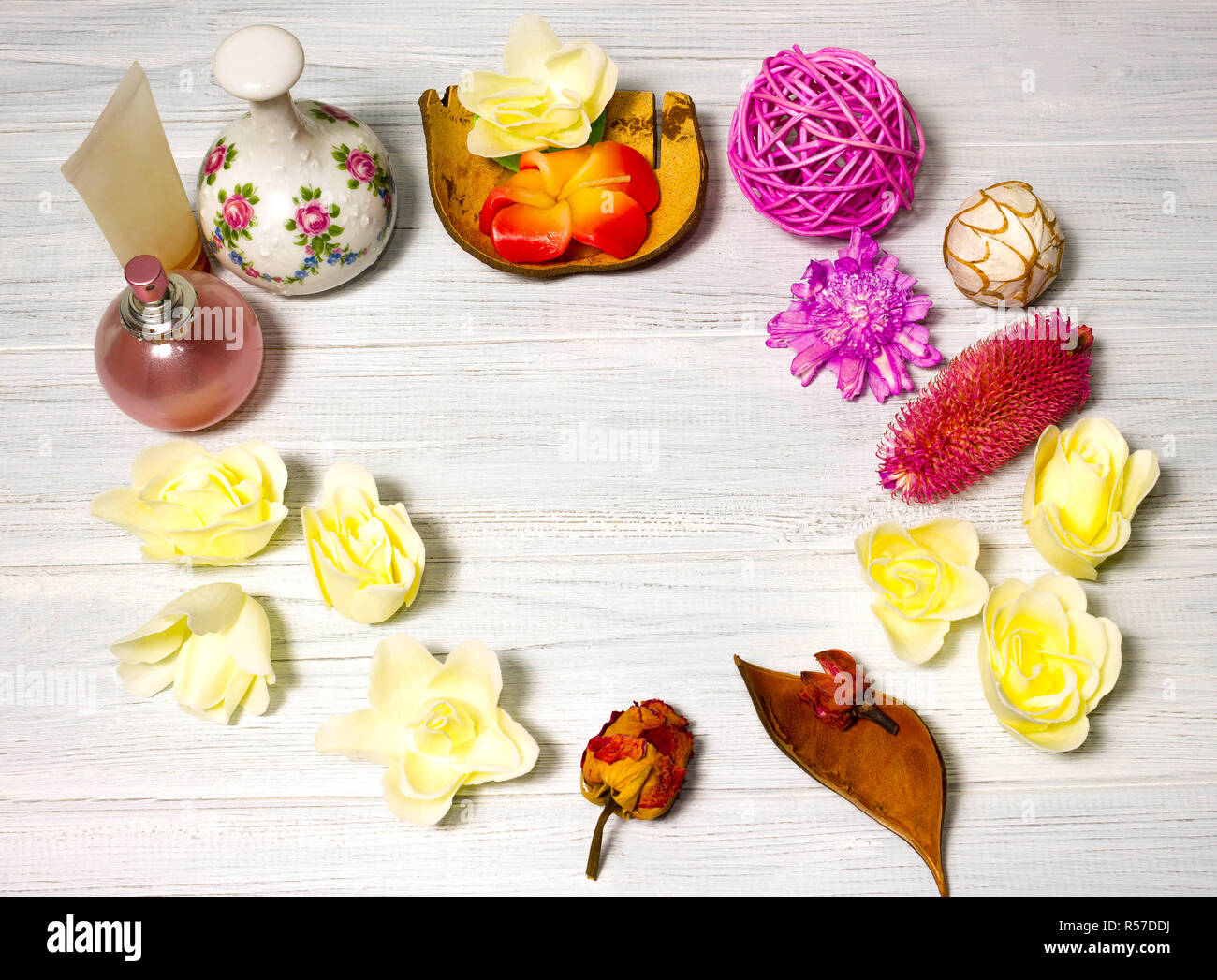 Beautiful spa setting with candle and flowers, balls on wooden board Stock Photo