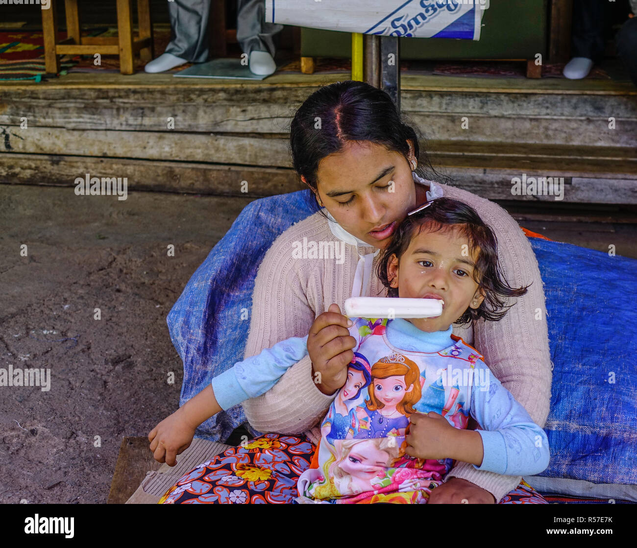 Taunggyi, Myanmar - Feb 8, 2018. A woman with her daughter in Taunggyi, Myanmar. Since 1962, Myanmar has become one of the poorest countries in the wo Stock Photo