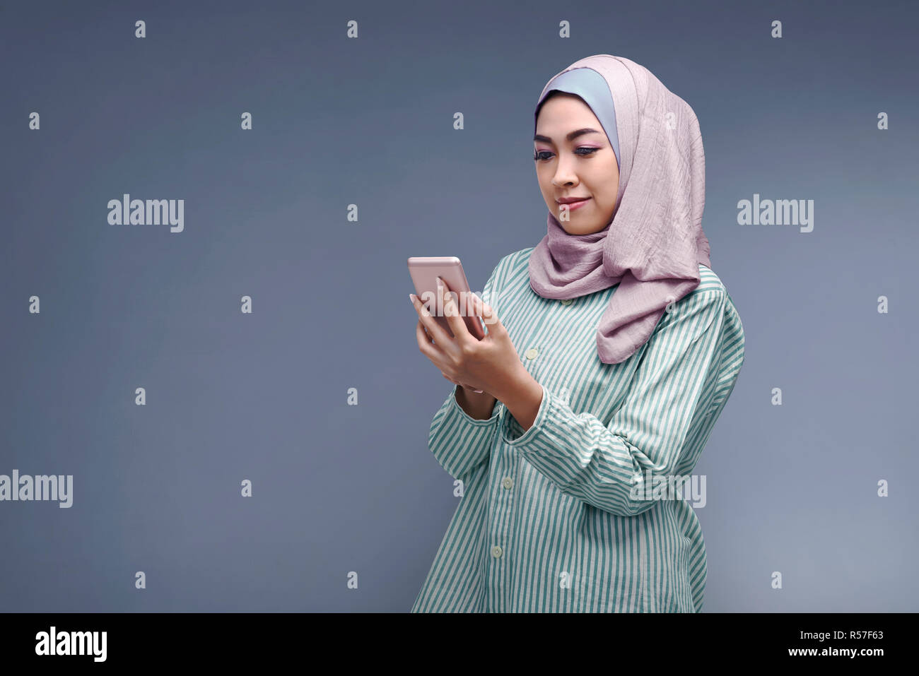 Young asian muslim woman in hijab with her smartphone Stock Photo - Alamy