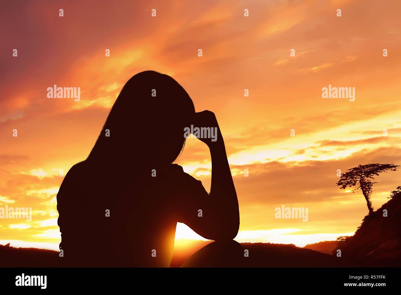 Silhouette depressed woman sitting alone on top of the mountain Stock ...