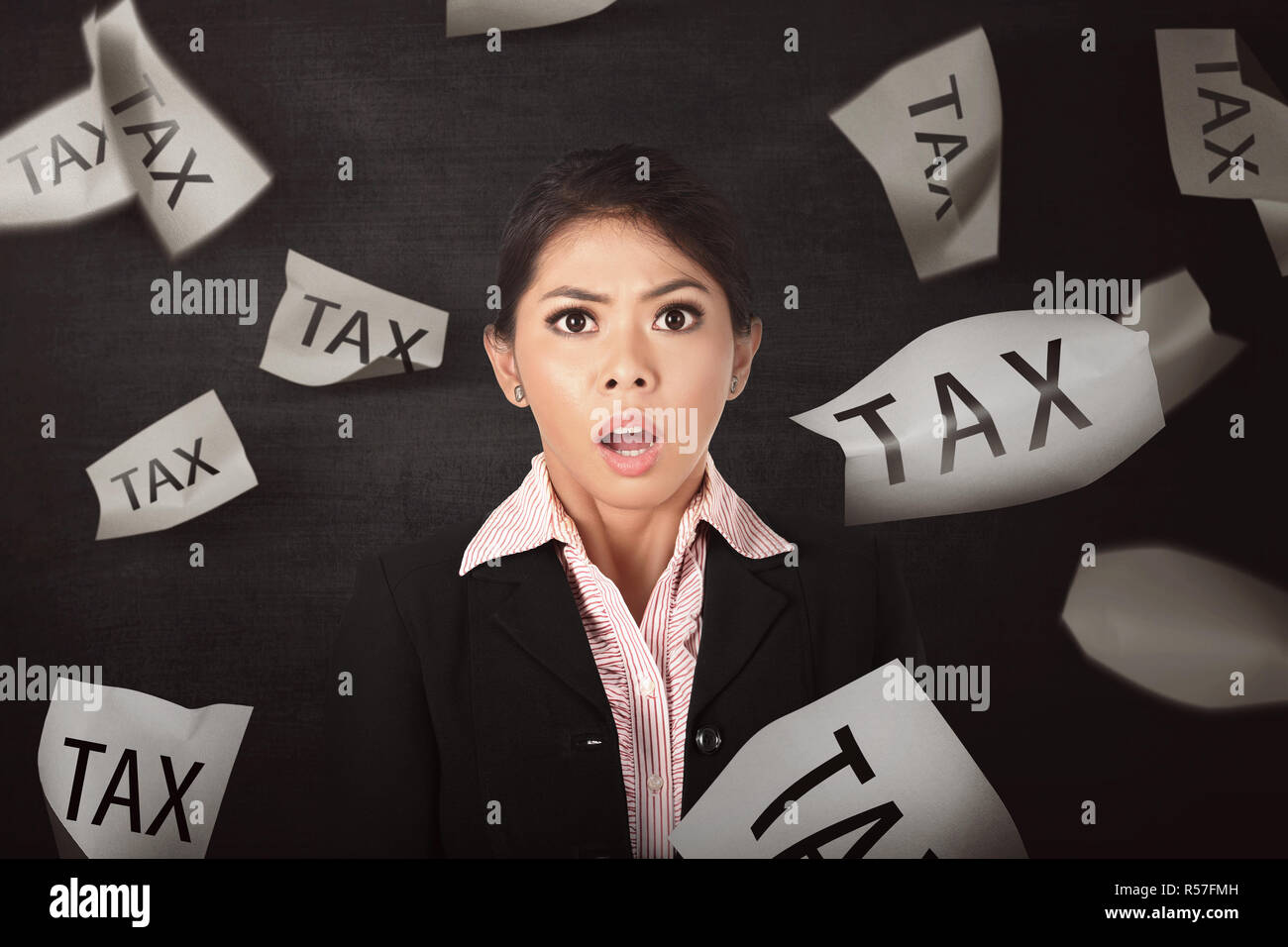 Beautiful asian business woman stressed because falling paper with Tax text Stock Photo