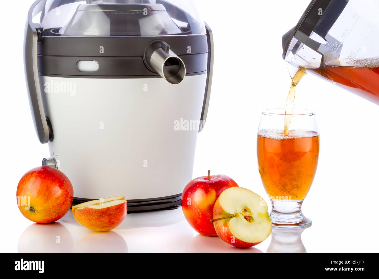 Electric juicer and apple juice in glass Stock Photo Alamy