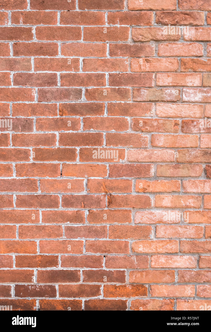 Old red brick rustic wall. It can be used as texture and background. Stock Photo