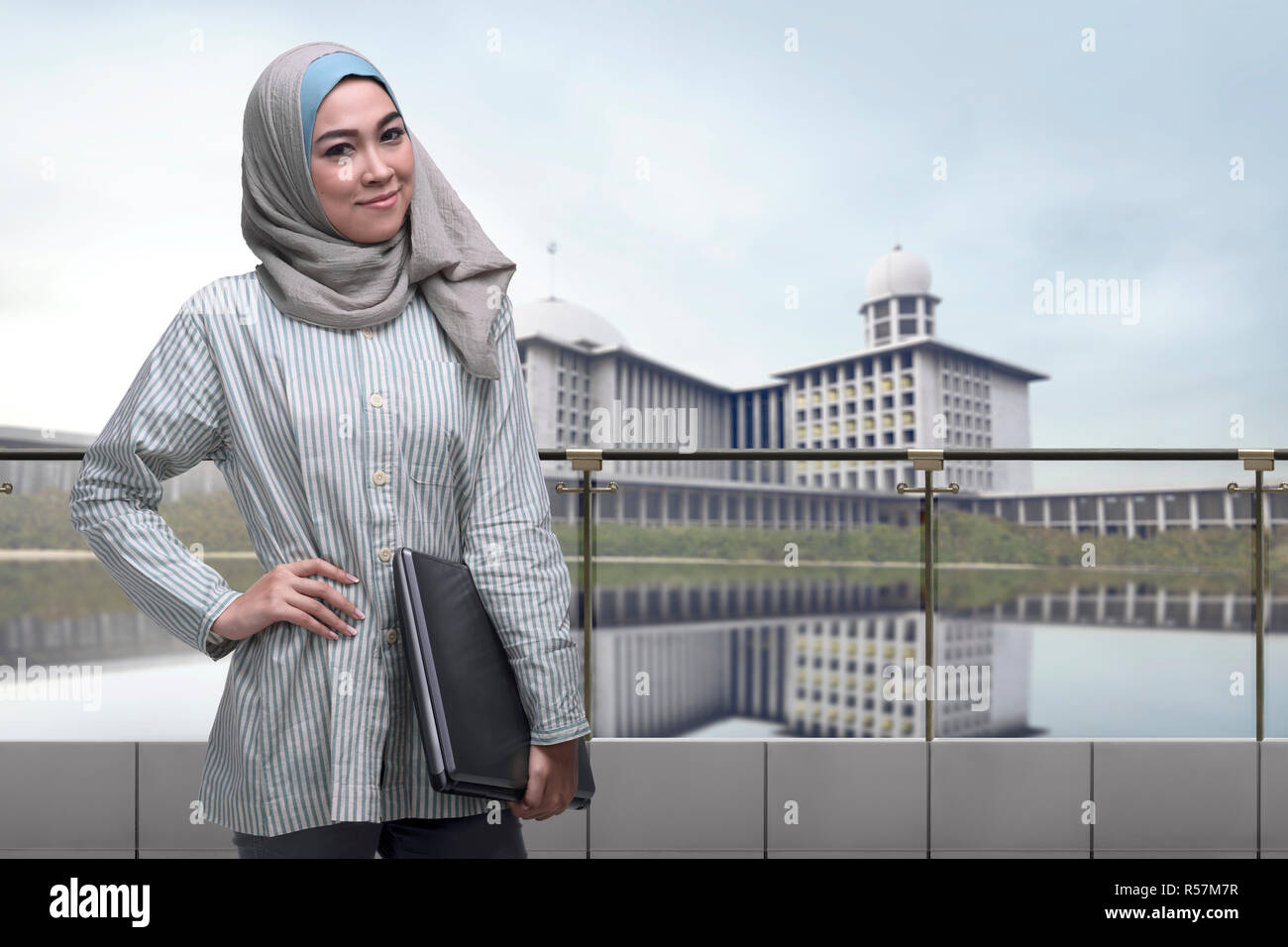 Portrait of asian muslim woman with hijab holding laptop Stock Photo ...