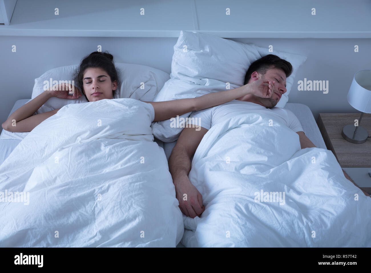 Woman's Hand On Husband Face While Sleeping Stock Photo Alamy