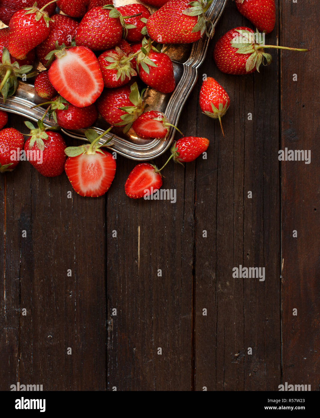 Strawberries in a tray on a wooden table Stock Photo - Alamy