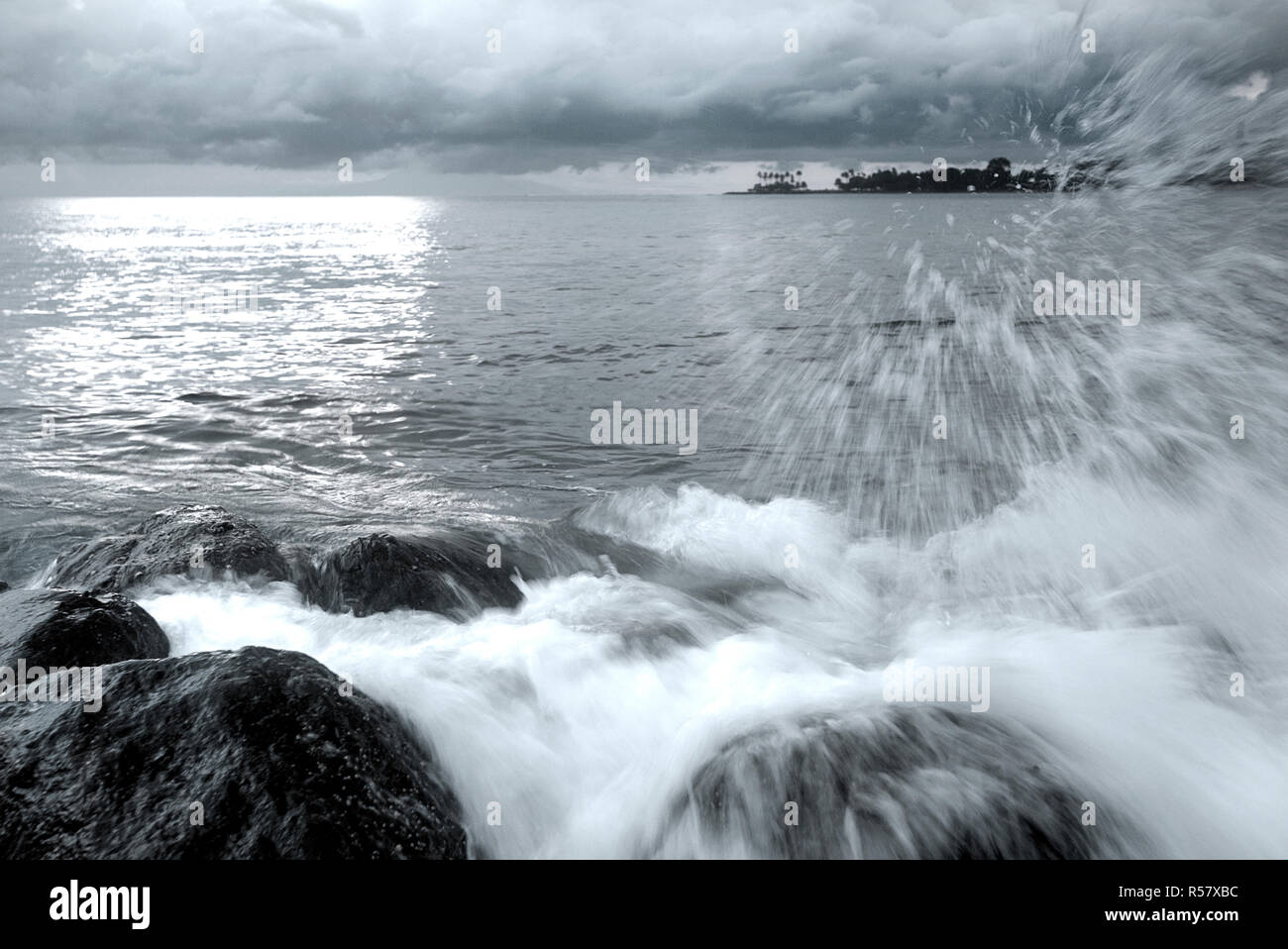 Waves splashing on a natural coastal rocks. Black and white. Stock Photo