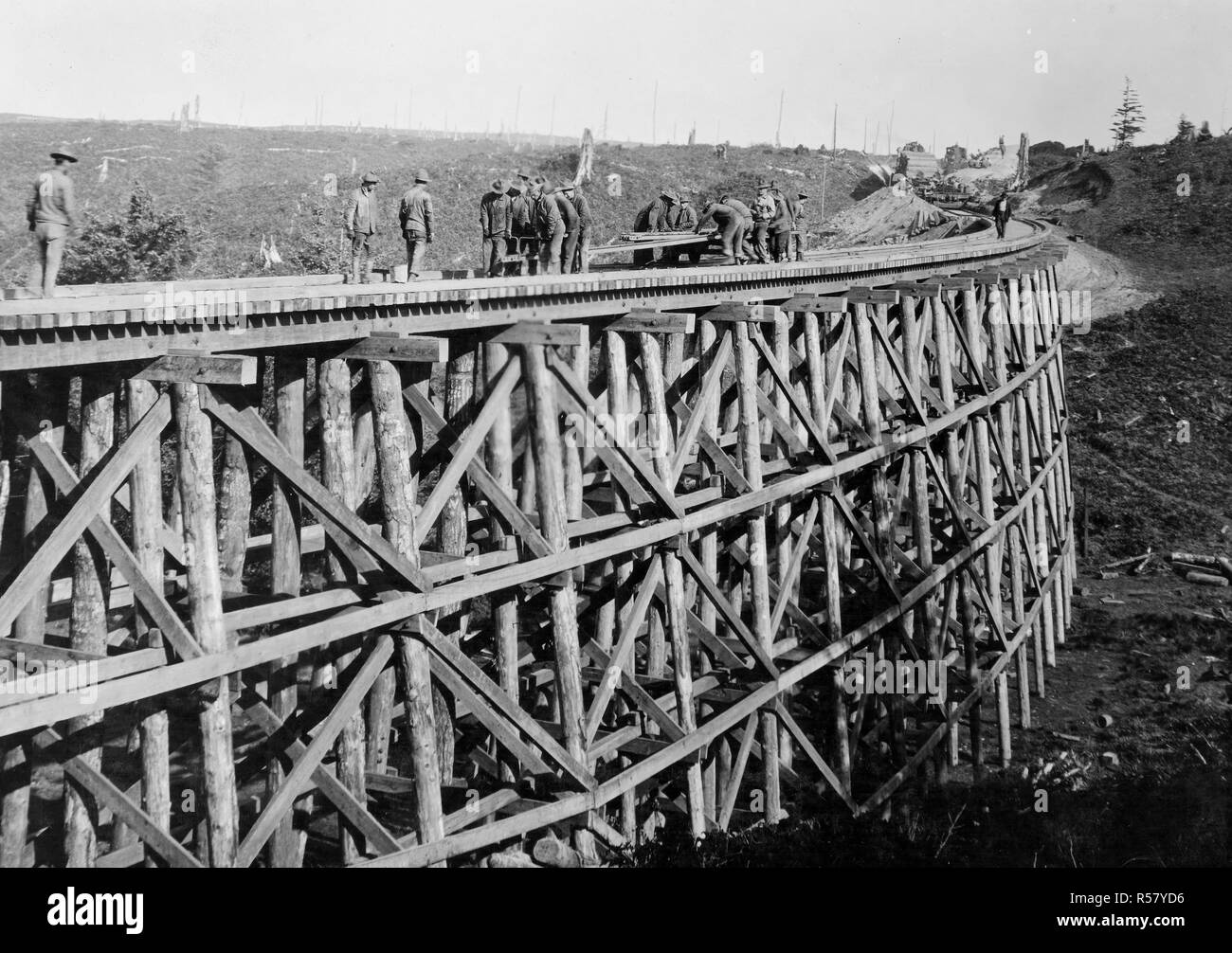 Industries of War - Lumbering - TRACK LAYING ON LINE SOUTH near Beaver Creek, rail laying from hand car on bridge ca. 1915-1920 Stock Photo