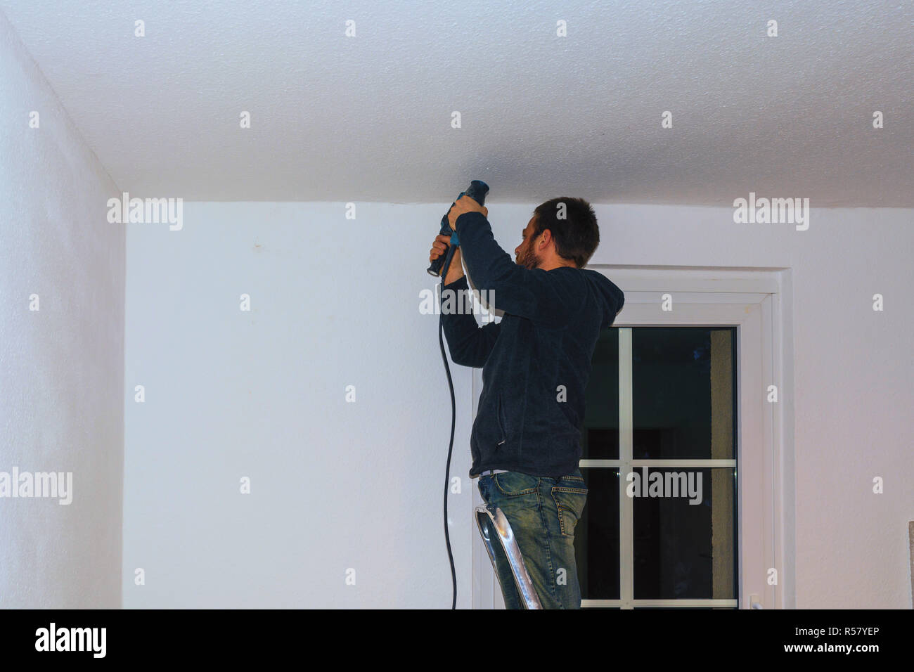 young craftsman with a power drill. Stock Photo