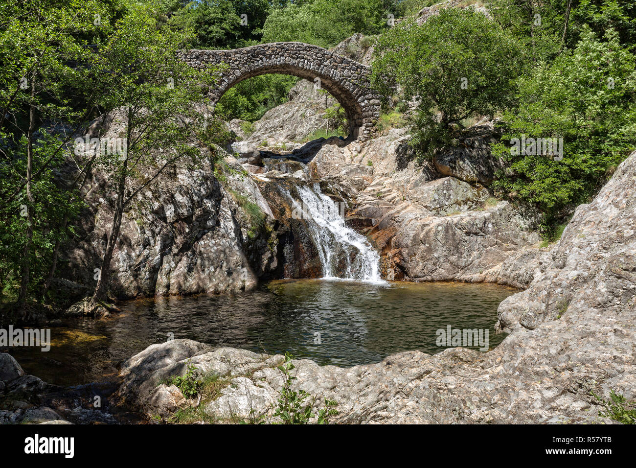 old stone bridge over a river in southern france Stock Photo