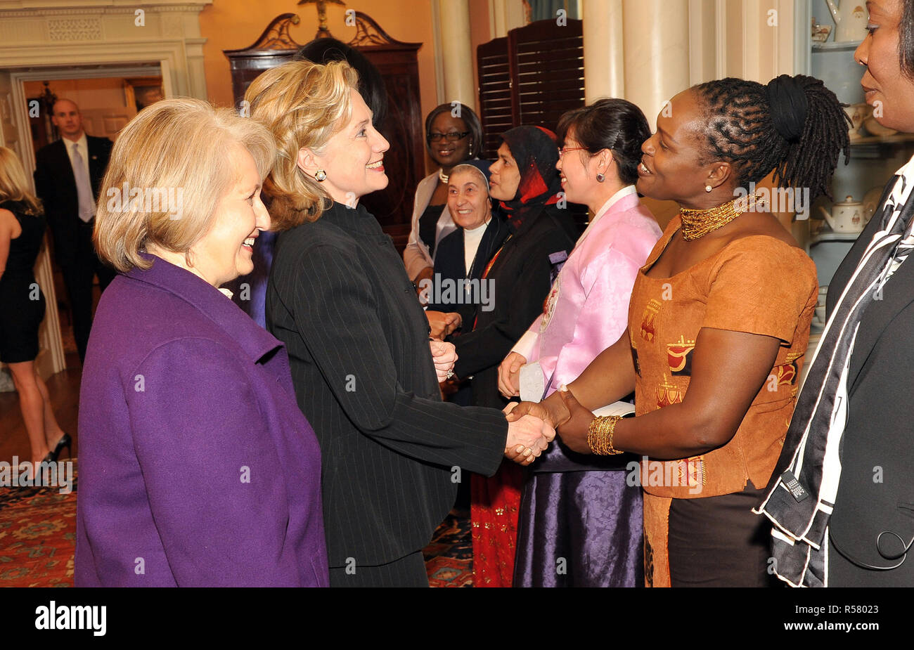 2010 - U.S. Secretary of State Hillary Rodham Clinton shakes hands with Honoree Ann Njogue of Kenya at the 2010 International Women of Courage at the U.S. Department of State, March 10, 2010. Stock Photo