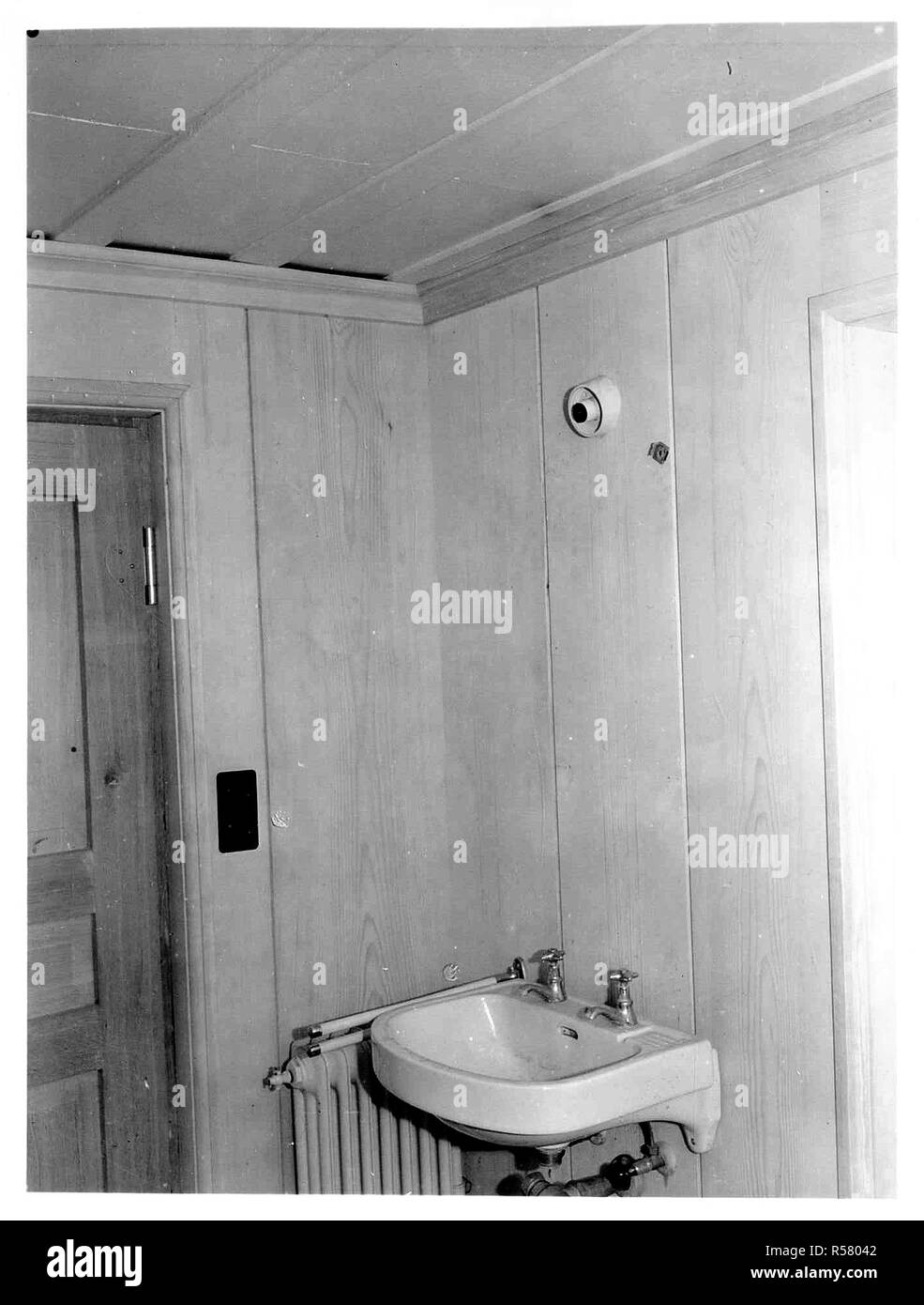 Original Caption: Interior view of bunker cabin, shoing modern plumbing and heating installations; electric light and wall plugs; and steel band reinforcing steel plated ceiling, in an abandoned German installation in the hills northwest of Soissons, France Stock Photo