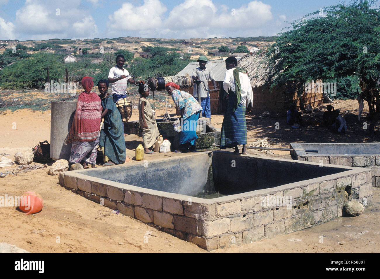 1993 - Somalis gather to draw from a well in the village.  The Moroccan Army maintains a base in Marka (Merca) Somalia Stock Photo