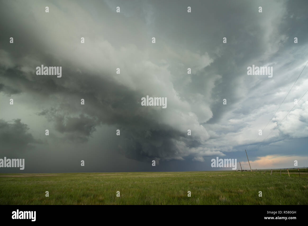 An arcing shelf cloud races forward as a severe thunderstorm approaches. Stock Photo